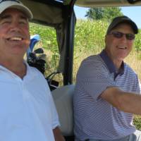 Two men in golf cart